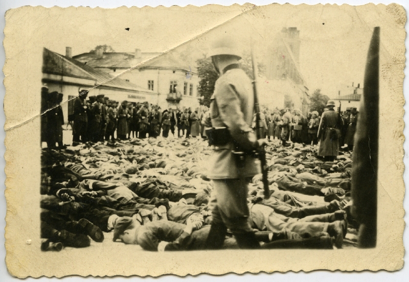 Olkusz. Aresztowani położeni twarzą do ziemi z rękami związanymi na plecach w oczekiwaniu na przesłuchanie, 30 VII 1940 r. [ze zbiorów IPN]. 